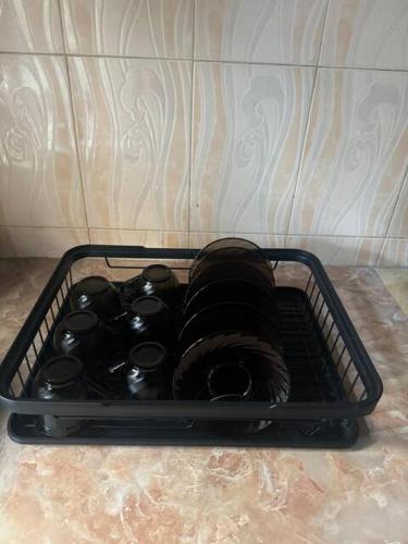 a black container sitting on the floor next to a couch at Karibu Homestay in Moshi