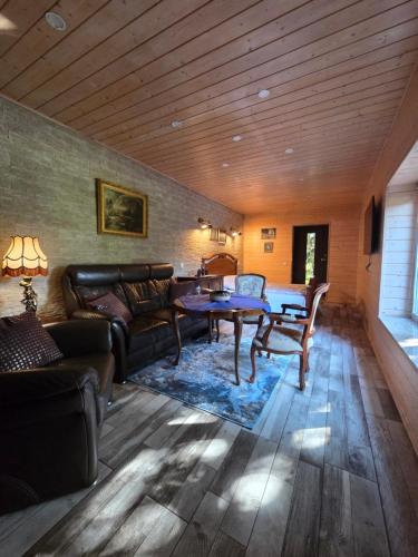 a living room with a couch and a table at Namelis Šventoji in Palanga