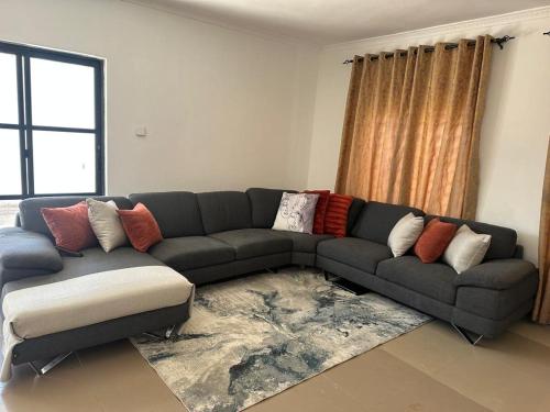 a living room with a couch and a rug at Black Pearl Inside Room in Lusaka