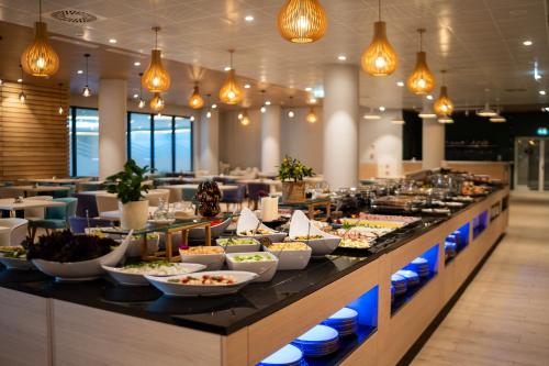 a buffet line with plates of food in a restaurant at PINEA Resort in Pobierowo