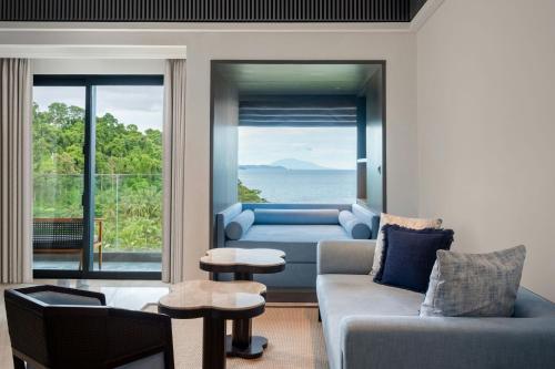 a living room with a view of the ocean at Lampung Marriott Resort & Spa in Lampung