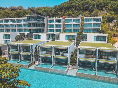 an aerial view of a building with a swimming pool at My Beach Resort Phuket, Panwa Beach in Panwa Beach