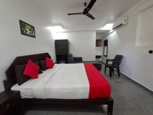 a bedroom with a large bed with red pillows at Raj Resort Calangute in Calangute