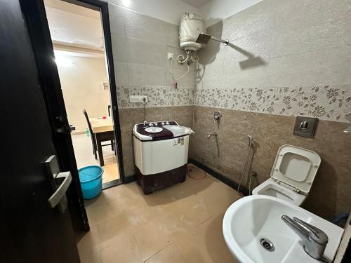 a small bathroom with a sink and a toilet at GetawayZ Rishikesh - 1BHK Luxury Flat - Tapovan 1BHK in Rishīkesh