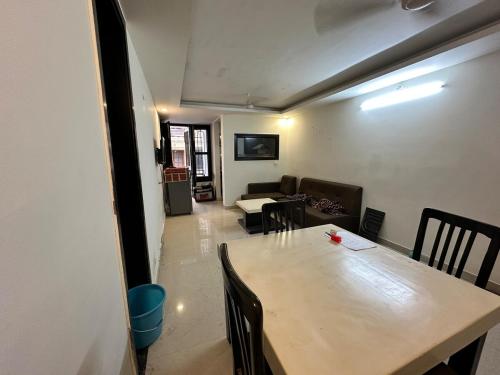 a dining room with a table and a couch at GetawayZ Rishikesh - 1BHK Luxury Flat - Tapovan 1BHK in Rishīkesh