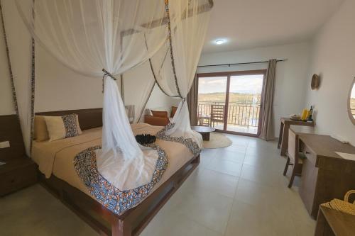 a bedroom with a swinging bed with a net at Africa Safari Karatu in Karatu