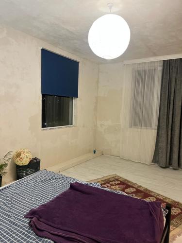 an empty room with a bed and a window at Almadovarhouse in Makhinjauri