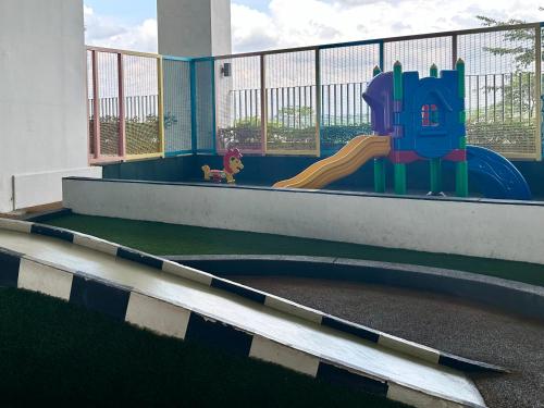 a playground with a slide in a building at Mid Valley Southkey Mosaic 3BR with WIFI 8-10 pax in Johor Bahru