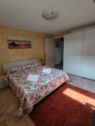 a bedroom with a bed with two phones on it at STELLA MARINA, Appartamento a 450 mt dalla costa del Mar di Sardegna in Portoscuso