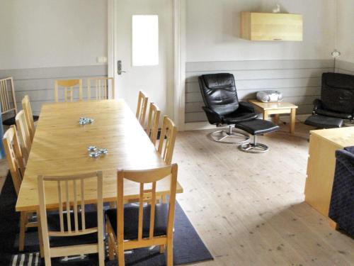 a dining room with a wooden table and chairs at 6 person holiday home in LJUNG-By Traum in Alboga