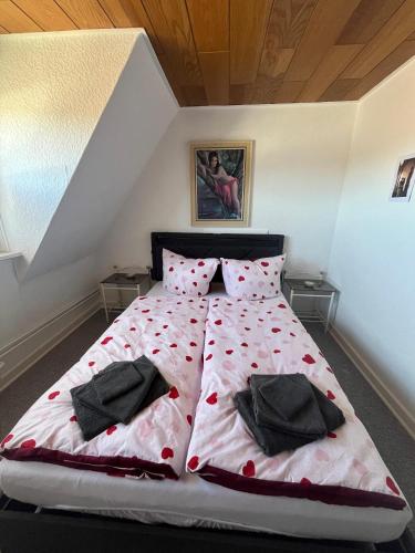 a bedroom with a bed with red flowers on it at Sperberhorst in Munster im Heidekreis