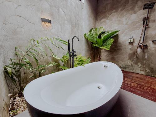 a white sink in a bathroom with plants at Royale Riviera Resort Private Pool Villas in Pantai Cenang