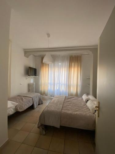 a bedroom with two beds and a window at Alfieri Panorama in Asti