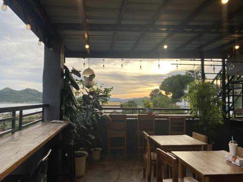 a restaurant with tables and a view of the water at Kalis Viewpoint Lodge Coron in Coron