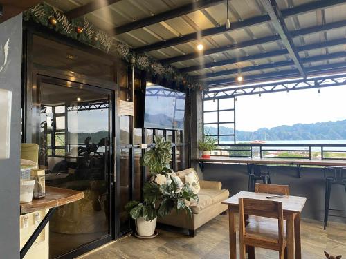 a living room with a couch and a table at Kalis Viewpoint Lodge Coron in Coron