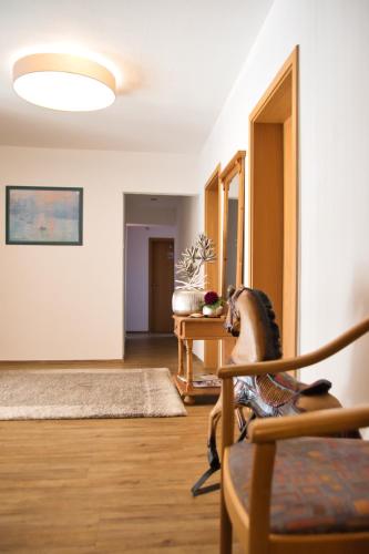 a living room with a chair and a table at Hotel Berg in Dannenfels