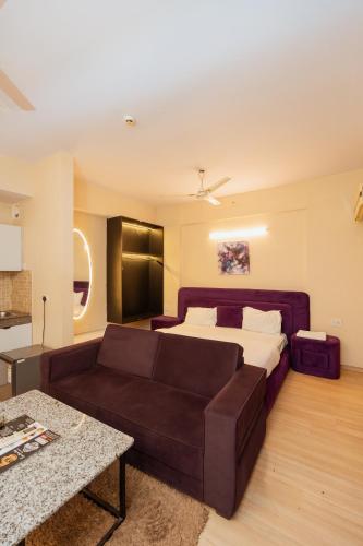 a living room with a couch and a bed at Skystay Lucknow in Lucknow