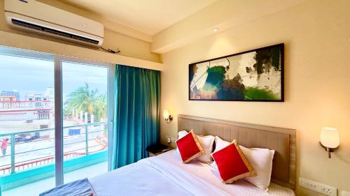 a bedroom with a bed and a large window at SEA VIEW- Family HOTEL NEW OTB , puri - near sea beach and Jagannath temple in Puri