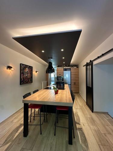 a kitchen with a large wooden table and chairs at Maison de charme Centre-Ville - WIFI Netflix - Terrasse - 2 cours extérieures in Auxerre