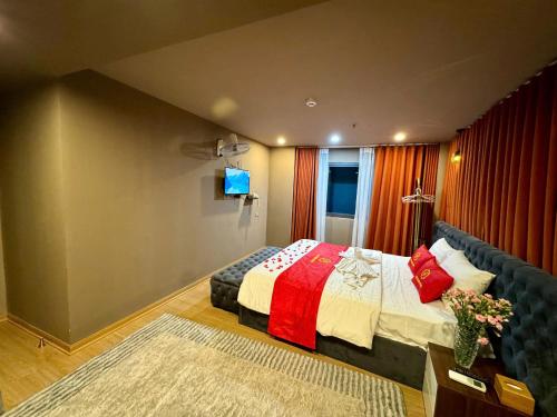 a bedroom with a bed and a couch at My House Hotel Hanoi in Hanoi