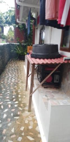 a table with a hat on top of it at Casa De Moore - Ocean & Garden View Siargao in General Luna