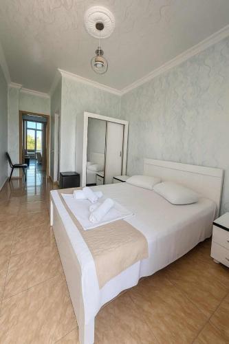 a bedroom with a large white bed in a room at Hotel Georgia in Gonio