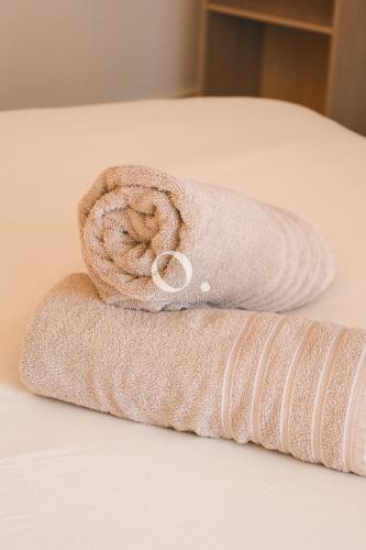 a roll of towels sitting on a bed at COC - Entre Terre Et Mer in Wissant