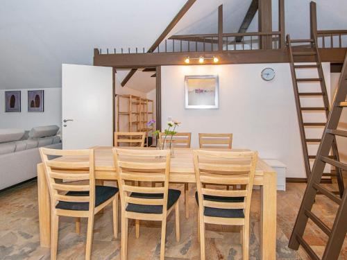 a dining room with a wooden table and chairs at 5 star holiday home in Ansager in Ansager
