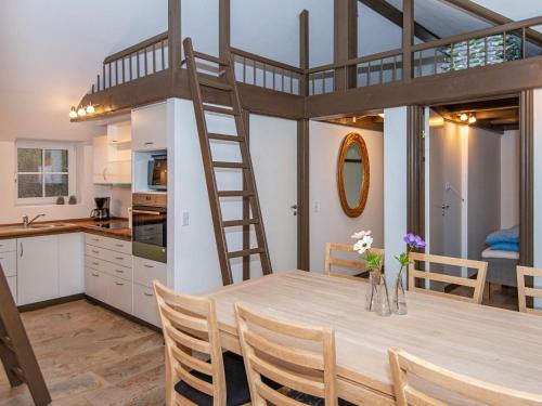 a kitchen and a dining room with a loft bed at 5 star holiday home in Ansager in Ansager