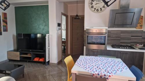 a kitchen with a table and a dining room at a due passi dal mare in Campofelice di Roccella
