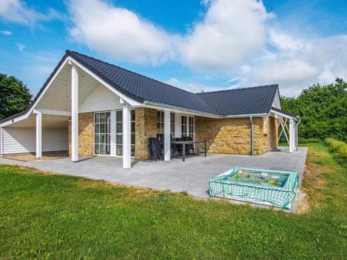 a home with a patio and a house at 5 star holiday home in Ansager in Ansager