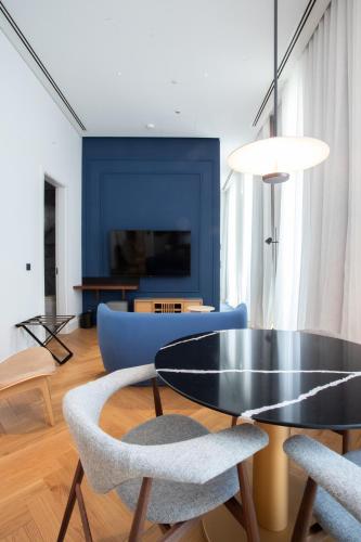 a living room with a black table and chairs at MACAM Hotel in Lisbon