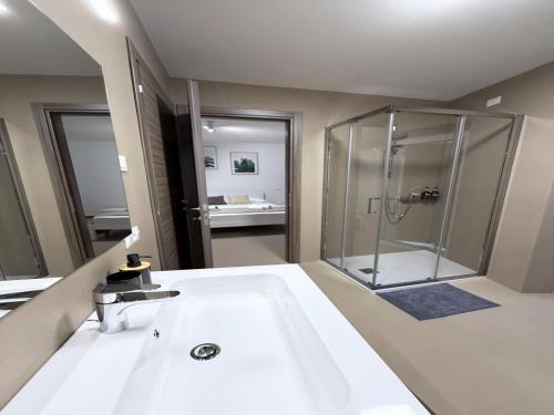 a bathroom with a shower and a white sink at Gomes Comfort House SUITE in Valeggio sul Mincio