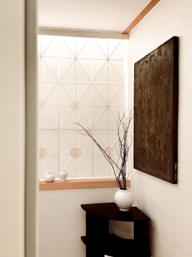 a window in a room with a vase on a table at Stay 42 Dongmyo in Seoul