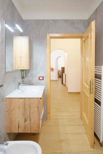 a bathroom with a sink and a mirror at Residence Al Caminetto in Molveno