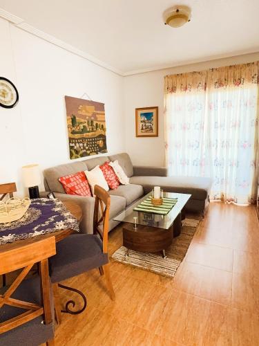una sala de estar con un sofá y una mesa en Costa Oasis Residencia La Mirada, en Orihuela Costa
