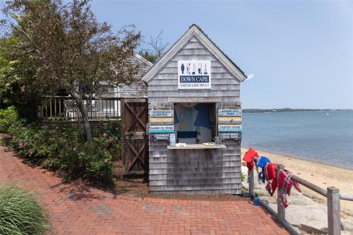 a small building on the beach next to the water at Wequassett Resort and Golf Club in East Harwich