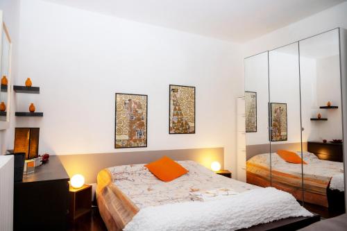 a bedroom with two beds and a mirror at Casa di Flo - Medieval City Centre with WiFi & AC in Ferrara