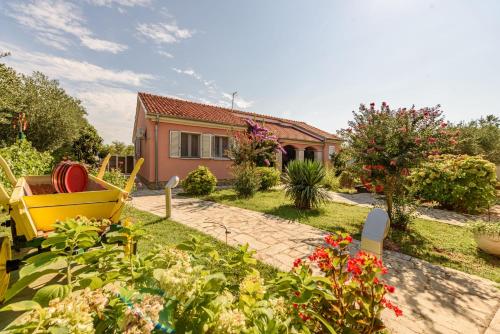 a house with a garden in front of it at Villa Štrkalj ZadarVillas in Murvica