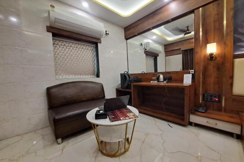 a waiting room with a chair and a table at Hotel Neelkiran in Navi Mumbai
