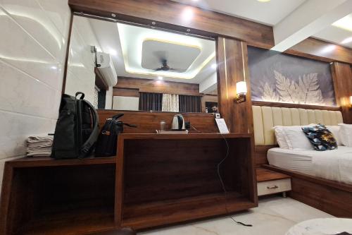 a bathroom with a sink and a mirror in a room at Hotel Neelkiran in Navi Mumbai