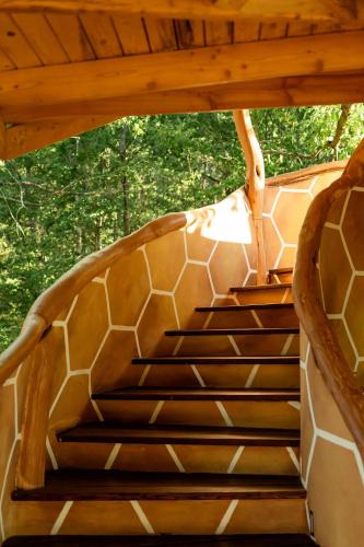 a staircase in a house with a wooden roof at Farkaskútvölgy in Felsőtold
