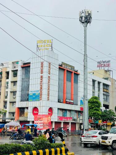 a busy city street with cars and buildings at Hotel Grand Lake in Ahmedabad
