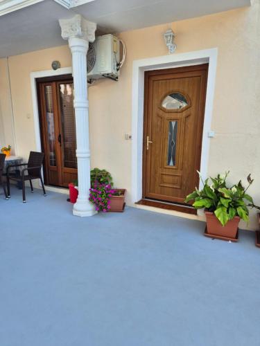 a front door of a house with potted plants at Apartmens Špiko 2 in Hvar