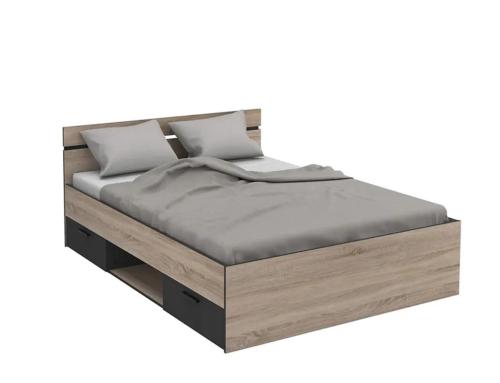 a bed with a wooden frame and pillows on it at Magnifique studio centre-ville in Nice