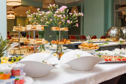 a buffet of food on a table with desserts at Luksusowe Apartamenty Echo in Cedzyna