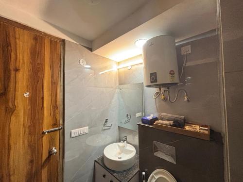 a small bathroom with a sink and a toilet at Housr Wakad Pune, Hinjawadi Road in Pune
