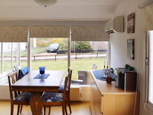 a kitchen with a table with chairs and a window at 5 person holiday home in MELLBYSTRAND in Mellbystrand