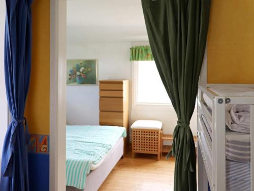 a small bedroom with a bed and a window at 5 person holiday home in MELLBYSTRAND in Mellbystrand
