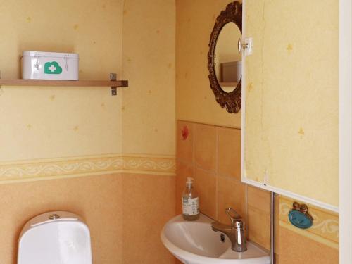 a bathroom with a sink and a toilet and a mirror at 5 person holiday home in MELLBYSTRAND in Mellbystrand